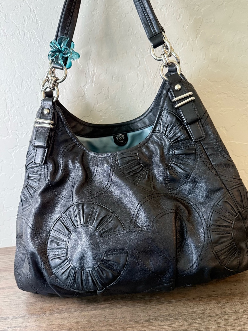 Coach Black Leather Shoulder Bag with Circular Appliqué